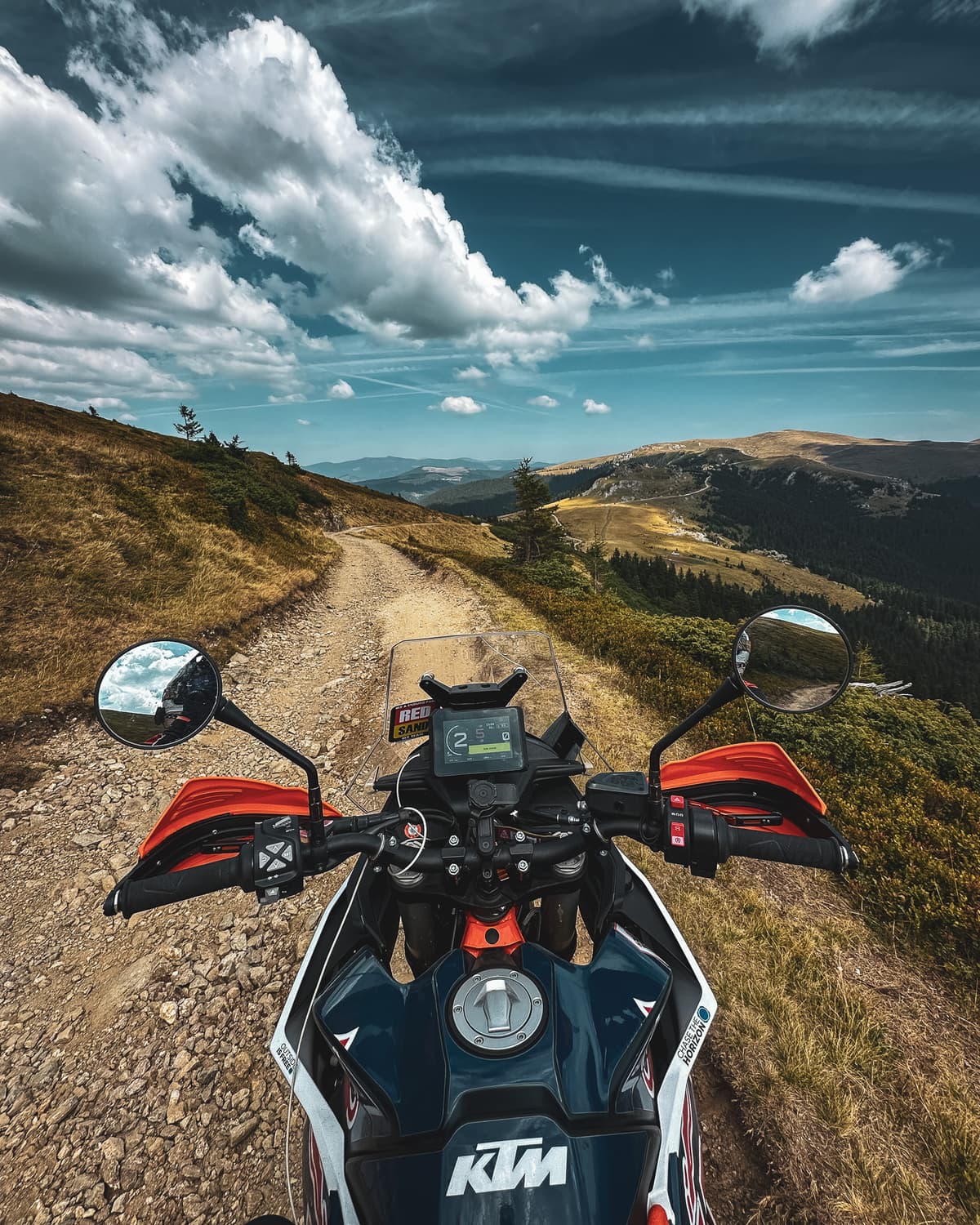 Cockpit point of view riding a rocky ridgeline trail