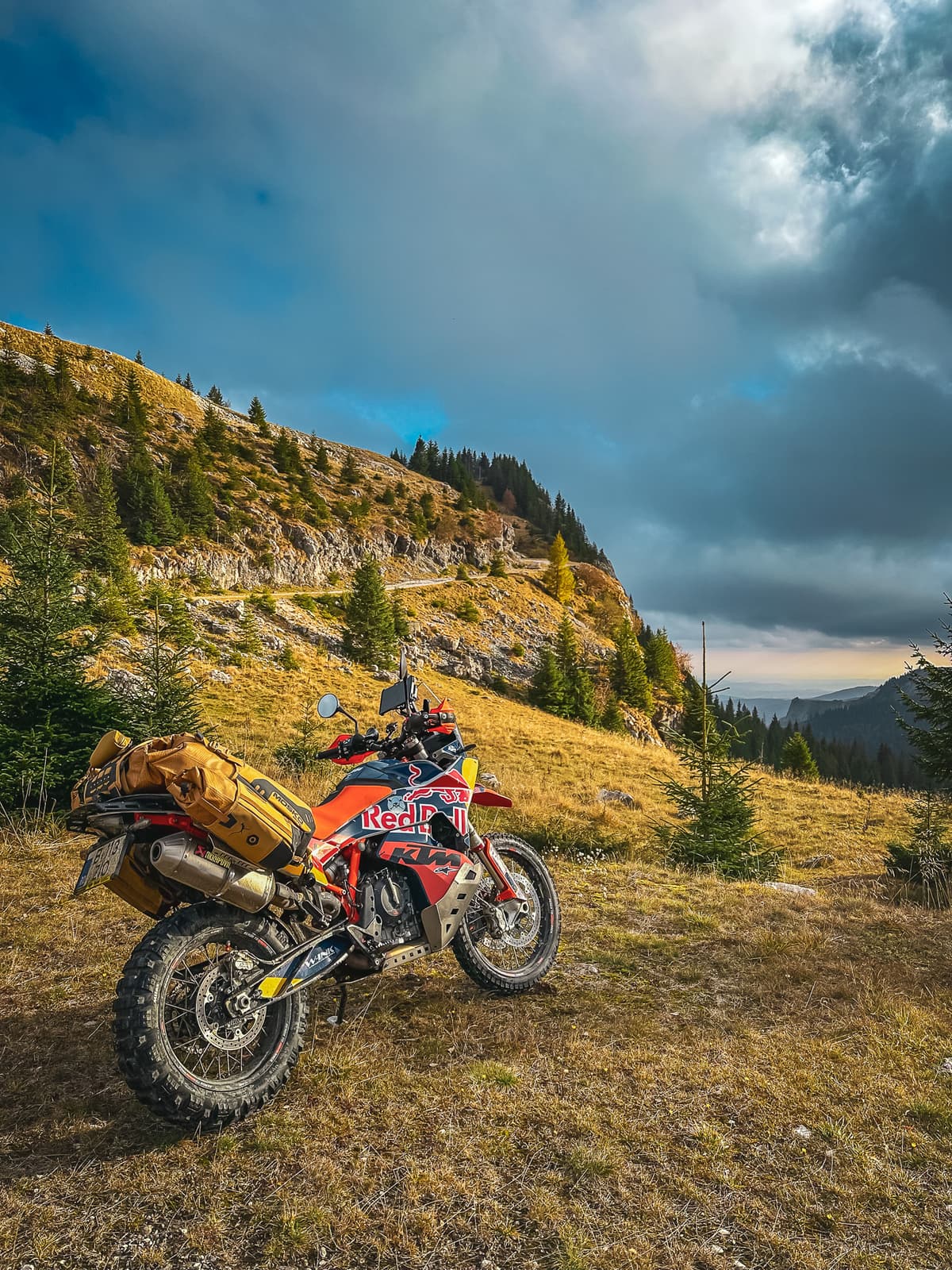 Loaded motorcycle in a high meadow at evening