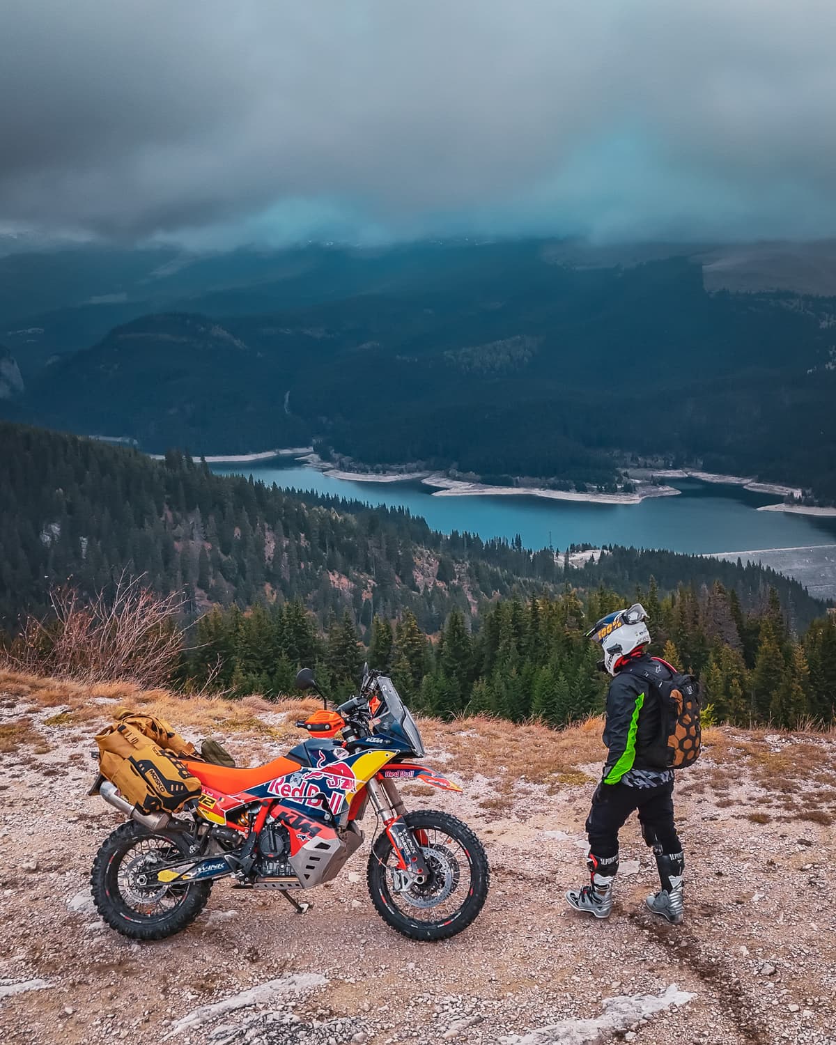 Rider standing above a lake