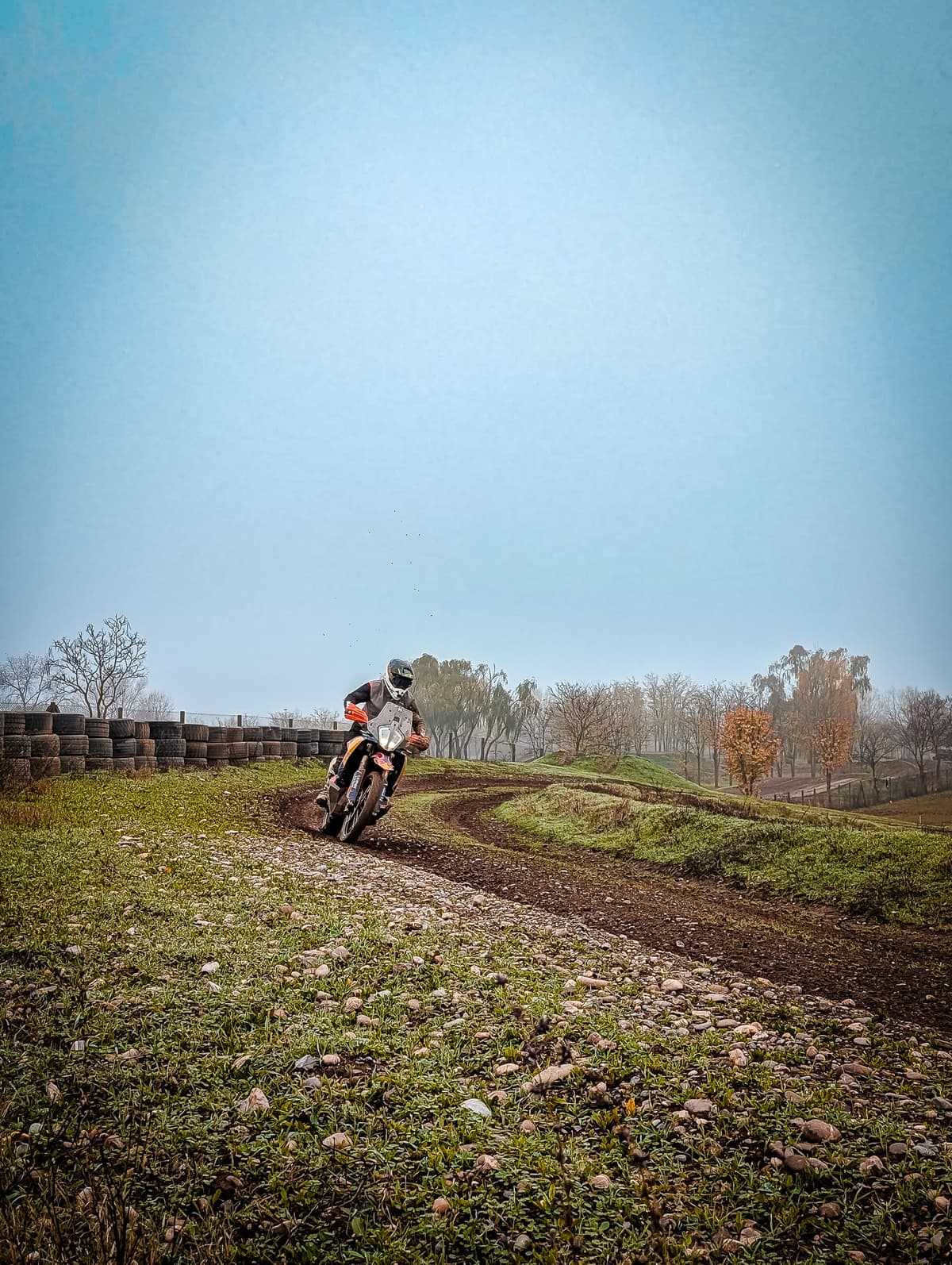 Foggy training track lined with tire barriers